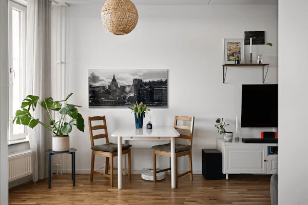 A small furnished apartment room with a table,
