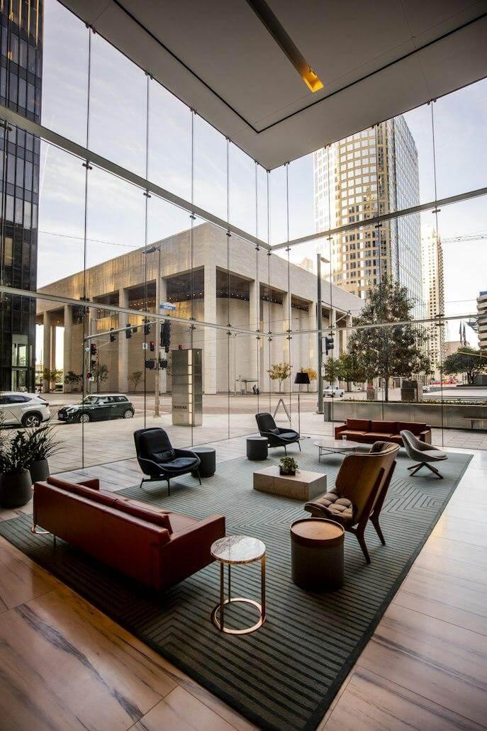 Biophilic living room with large windows and comfortable furniture