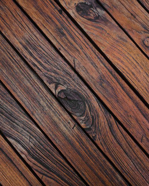 Why Modern Structural Decking Upgrades Protect Homes Against Wild Seasonal Weather 2 Close-up of wooden floor with knots, suitable
