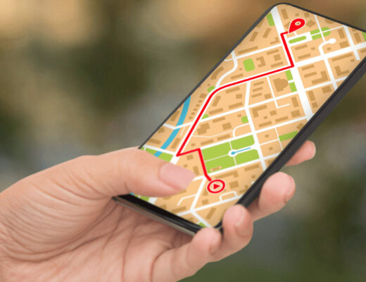 Person holding a smartphone displaying a map,