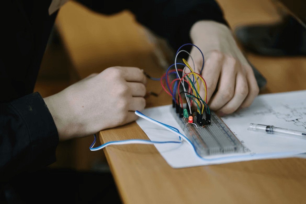 Leveling Up Your Electronics Skills as a DIY Business Owner 2 Person working on an electronics project with wires