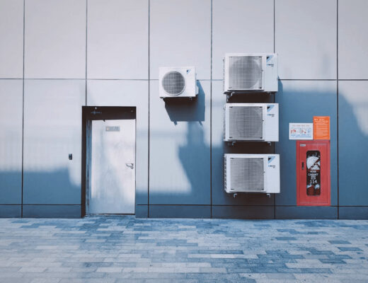 Two air conditioner units on the side