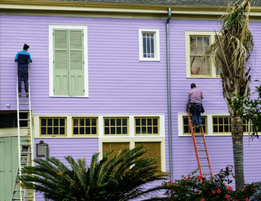 DIY Exterior Paint That Survives Desert Heat 2 Two men painting a purple house with DIY exterior