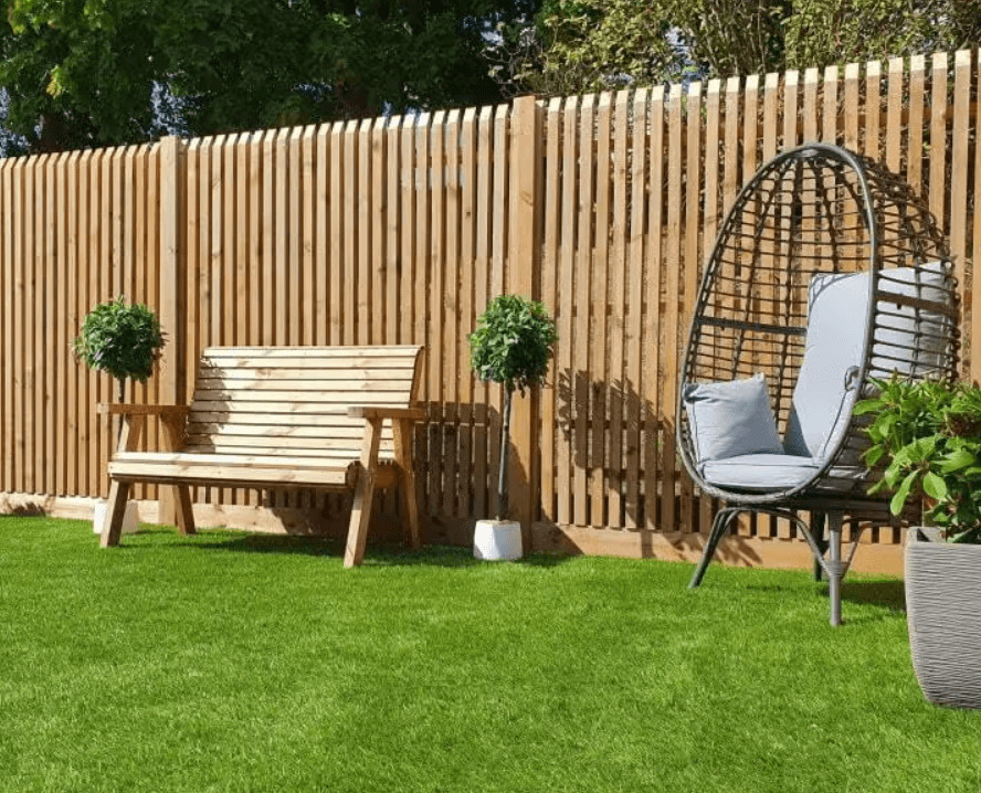 Why Upgrading Your Garden Fence Can Maximize Your Curb Appeal 2 Well-maintained wooden garden fence with a chair and