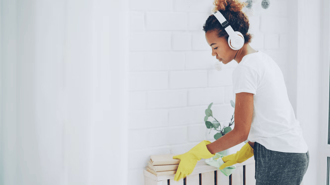 How to Reduce Household Dust and Improve Indoor Air Quality 1 Woman cleaning a radiator to reduce household dust
